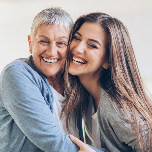 mom and daughter smiling