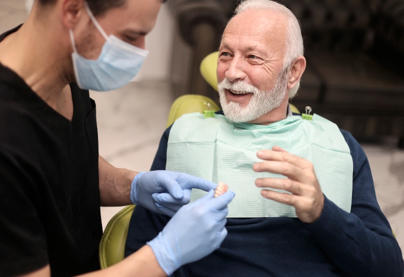 A smiling senior receiving quality care with dentures in Millersburg, OH, from a skilled dentist