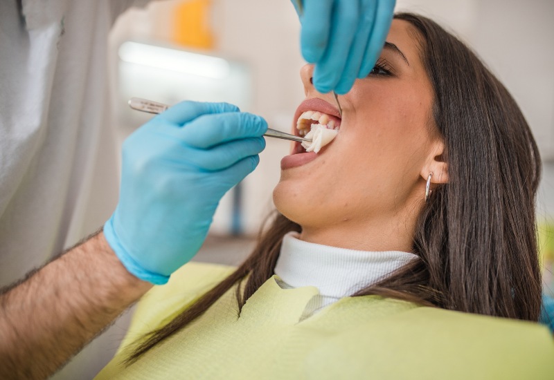A patient receives dental care after a tooth extraction, focusing on aftercare in Millersburg, OH