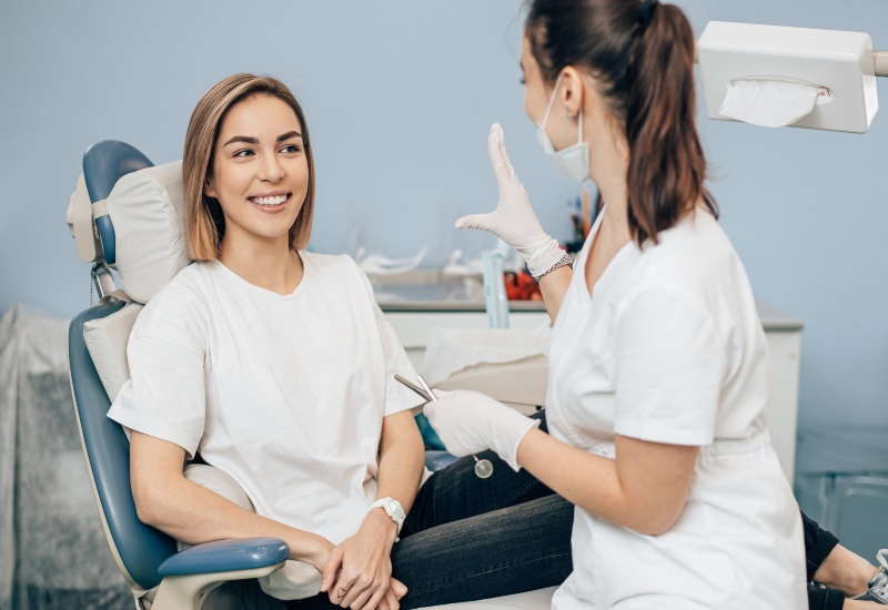 A smiling patient receiving general dental advice from a professional dentist in Millersburg, OH