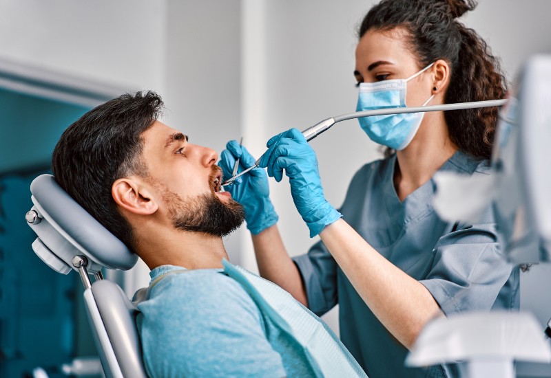 A dentist performing restorative dental treatment on a patient in a dental clinic in Millersburg, OH